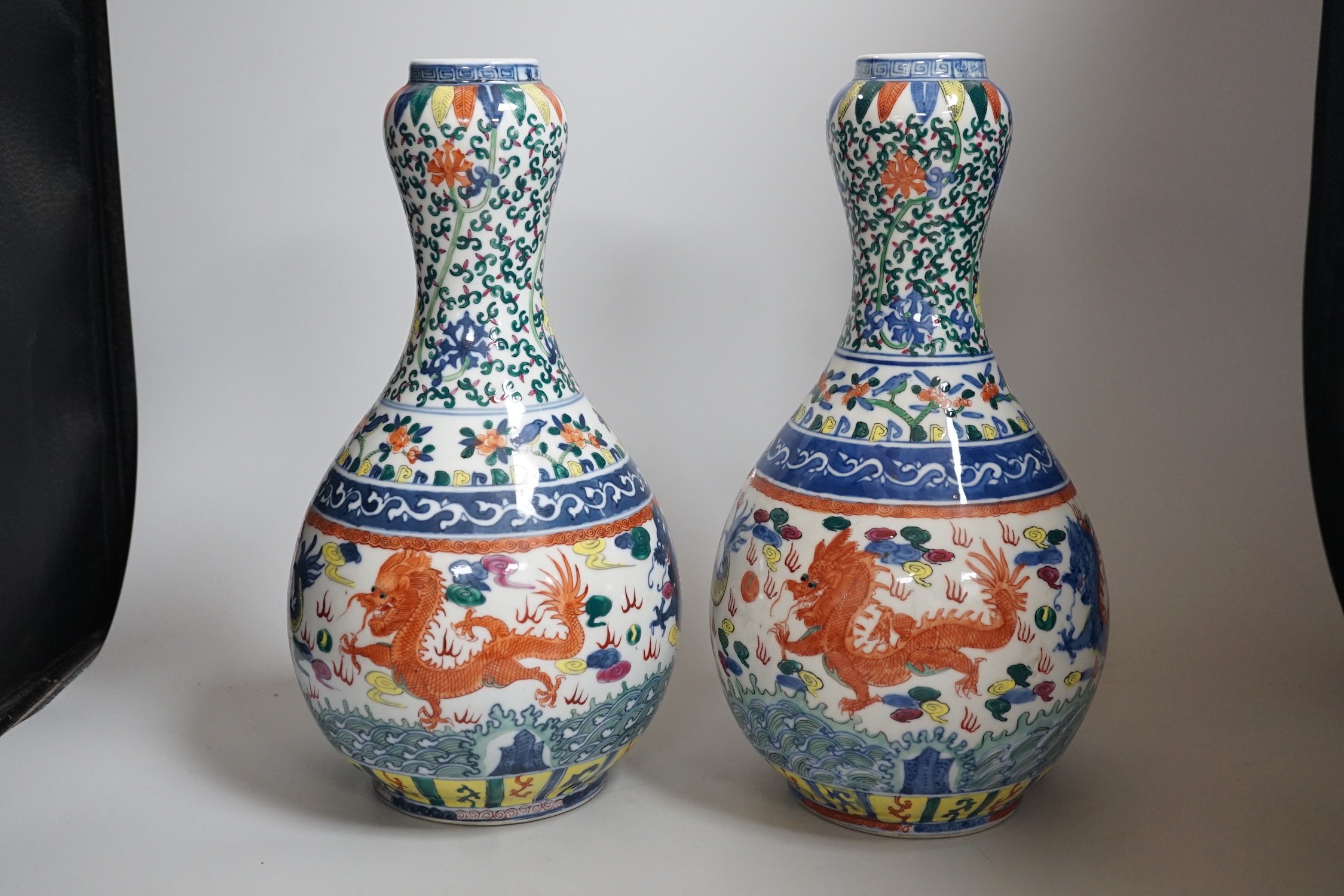 A pair of Chinese Wucai decorated vases, 34cms high